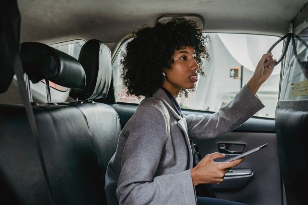 Passenger seated in the back seat of a taxi