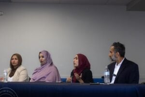 Furqan Mohammed seated with three fellow panelists at the Muslim Pre-Law Conference 2026 at College Preparatory School of America
