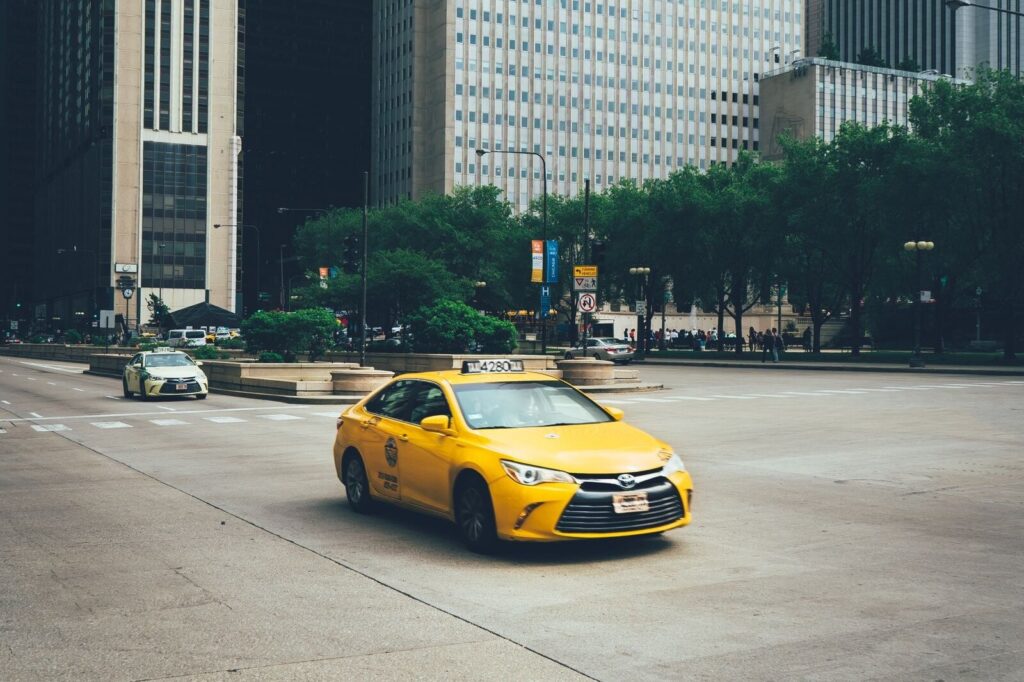Yellow taxi driving through downtown Chicago
