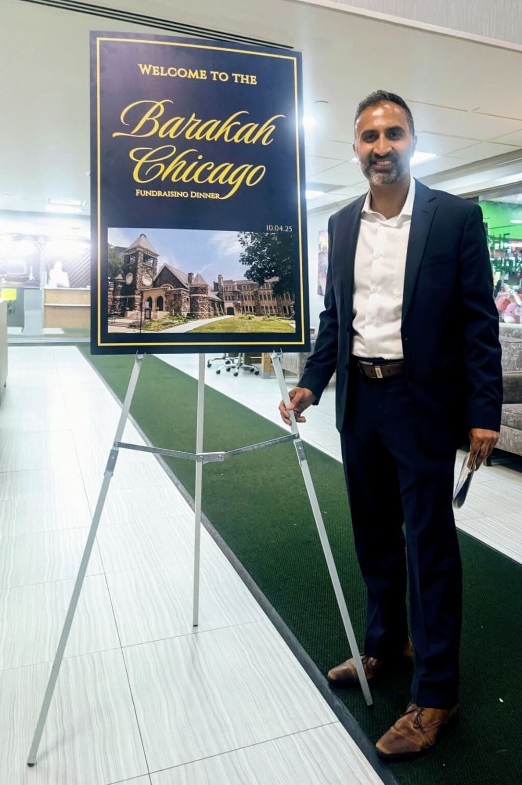 Furqan Mohammed at the Barakah Chicago fundraiser beside the event welcome sign