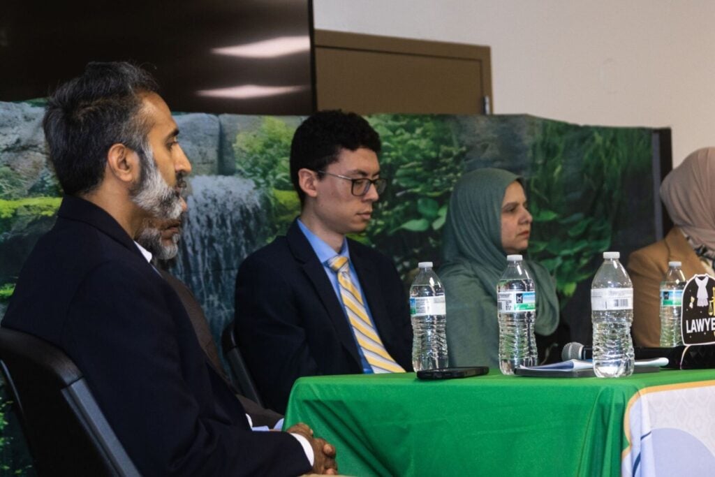 Furqan Mohammed seated with fellow panelists at the Pathway to Law panel at the MEC Banquet Hall in Morton Grove